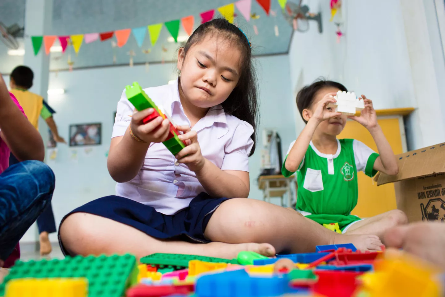Ngo Diep Uyen (10) suffers from mental and learning disabilities plays with lego toys at the DAVA Center in Hoa Vang district outside of Da Nang, Vietnam.