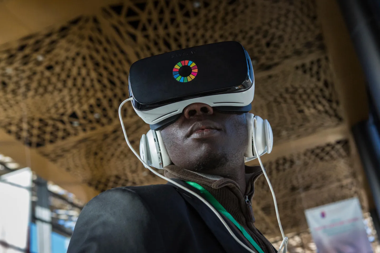 Journalist Babacar Fall, wearing a headset, watches a virtual reality video at the UNICEF exhibition at the Global Partnership for Education (GPE) Financing Conference in Diamniadio, Senegal