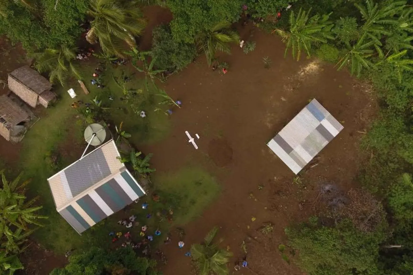 Swoop Aero drone comes into land at Cook&rsquo;s Bay, after taking off from Dillon&rsquo;s Bay and flying 25 minutes over the mountainous terrain, to deliver vaccines to the registered nurse, Miriam Nampil, who is waiting to vaccinate 13 children.