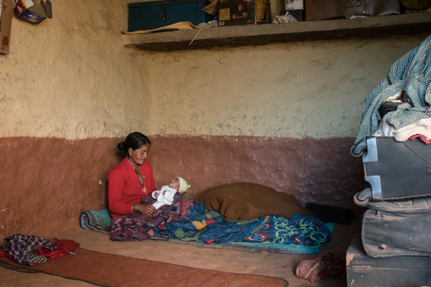 Janaki Odh is playing with her 16-day old baby girl Nisha in their house in Joshibunga, a village in Baitadi District, far western Nepal.