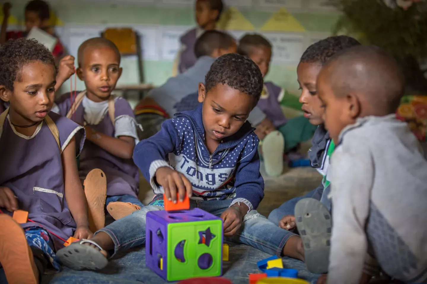 Abel Chane, 6, plays while his friends watch