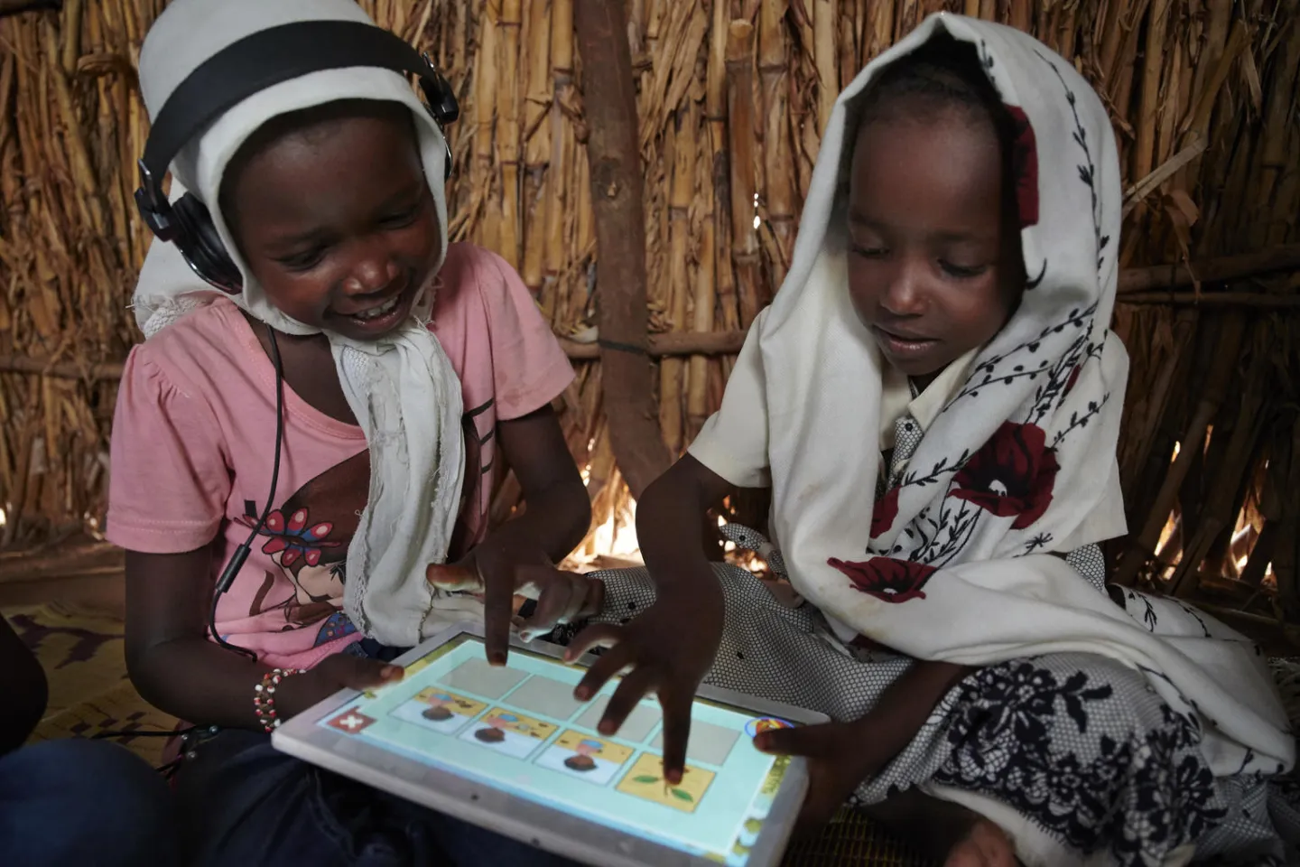 Children use their tablet and work with each other and learn 