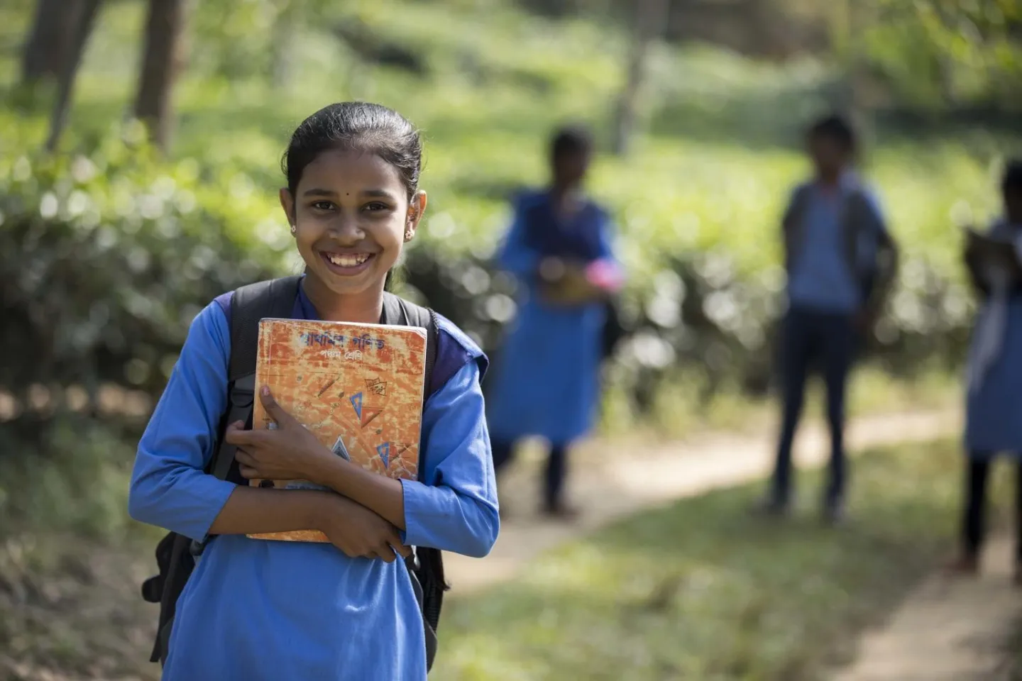 Young student holding a book in a school in Bangladesh