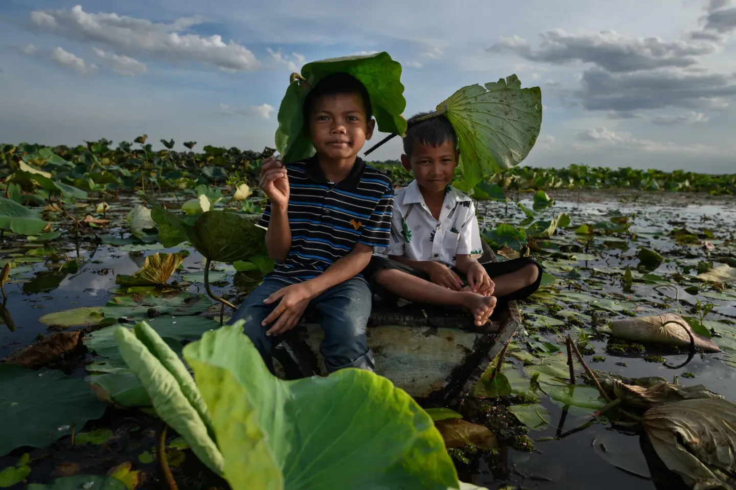 boys sitting in water