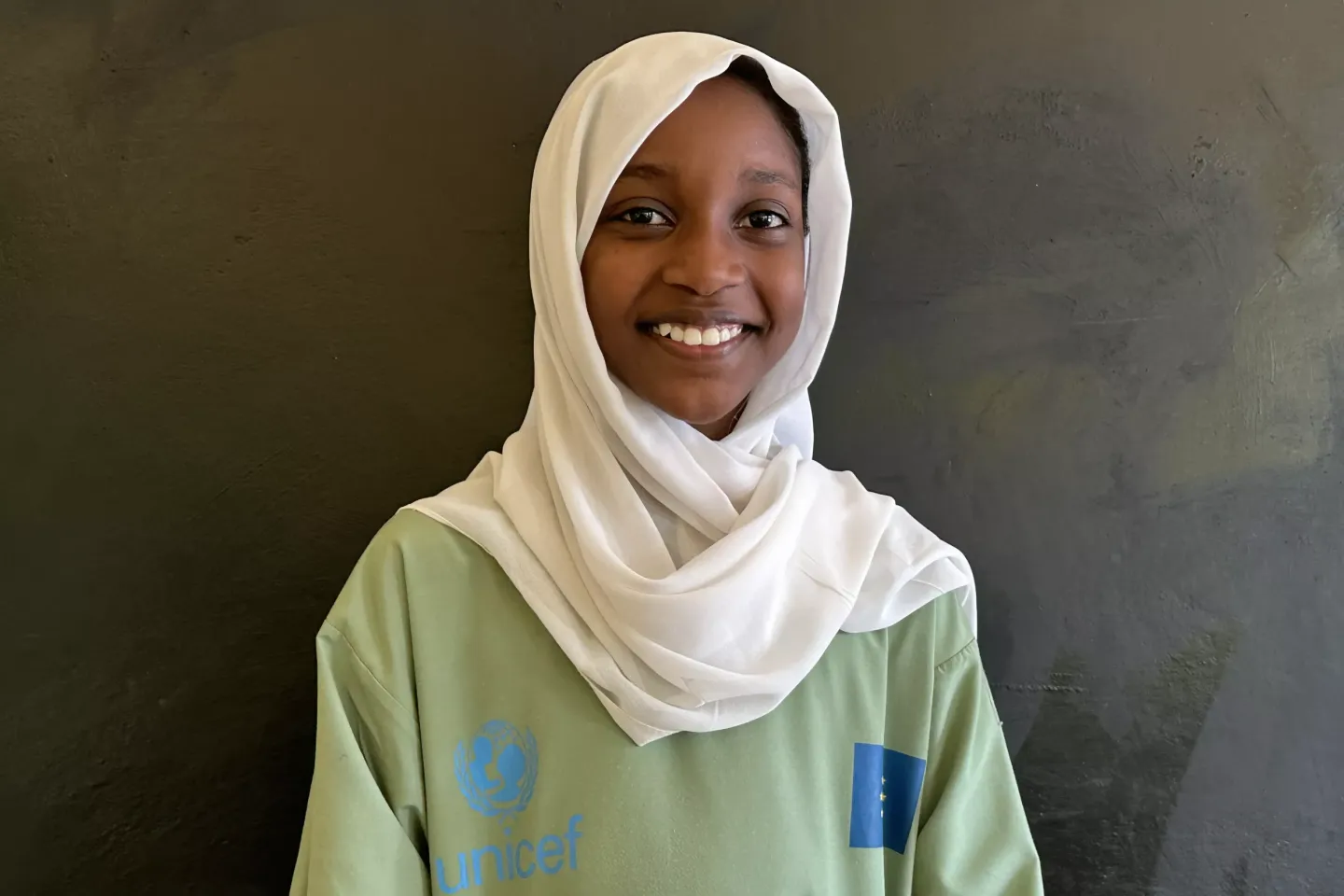 Student smiles in a classroom