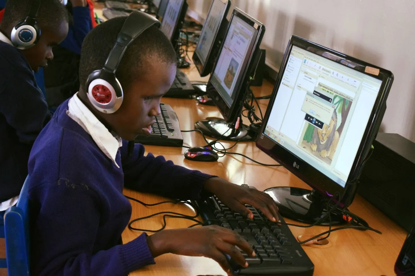 Student at Thika Primary School for the Visually Impaired in Kenya reading accessible storybooks using eKitabu&rsquo;s e-reader app