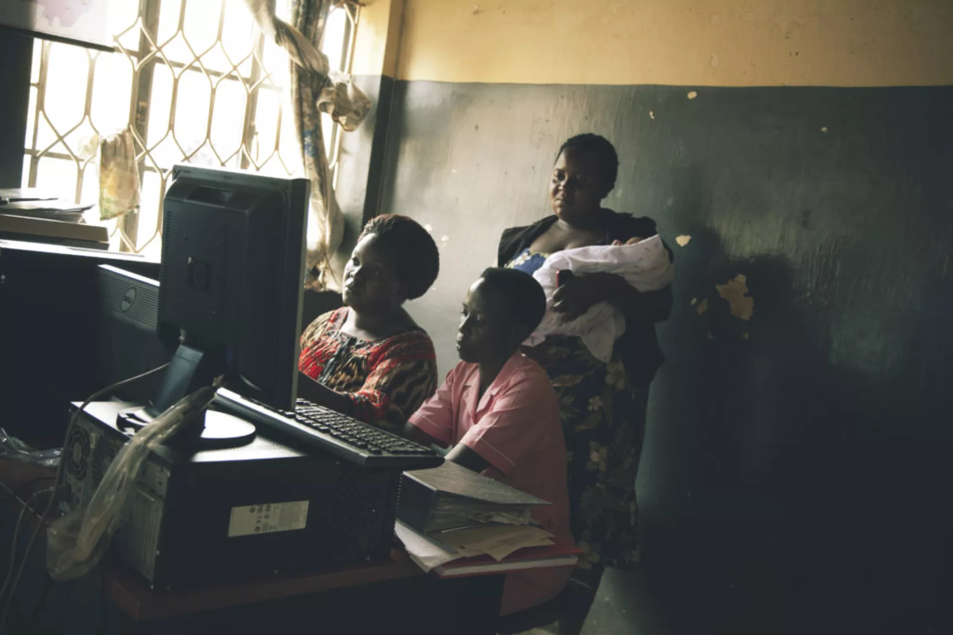 Health workers look at the monitor screens