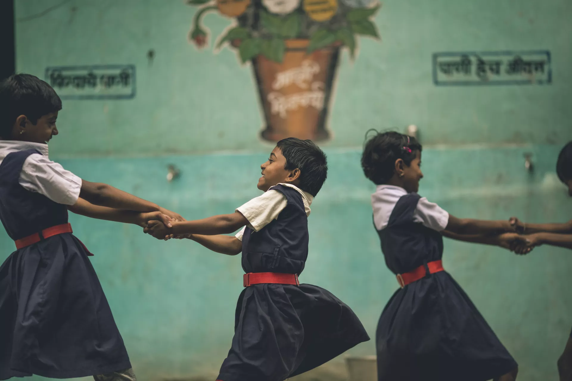 Children holding each others arms 