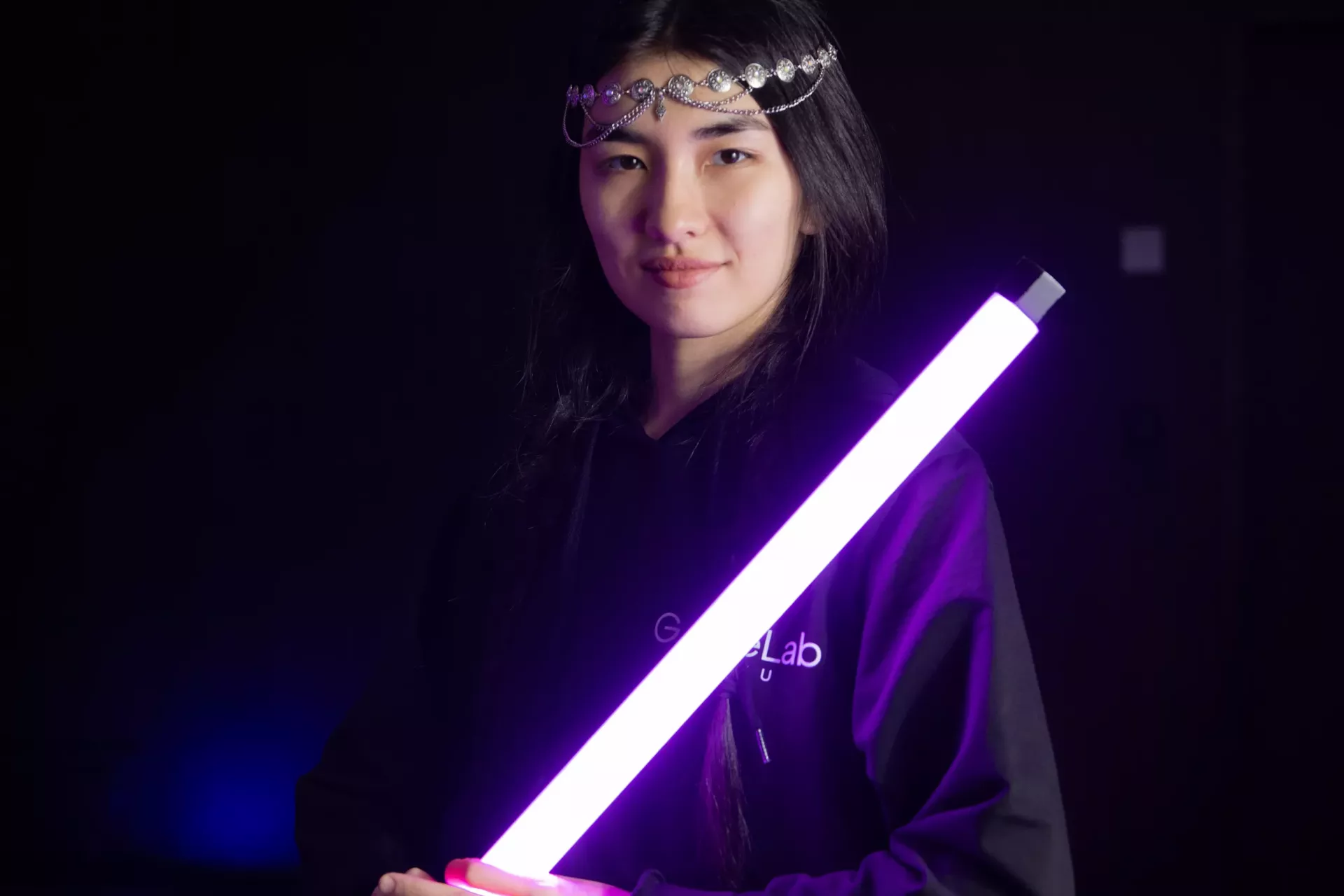 girl holding a light saber