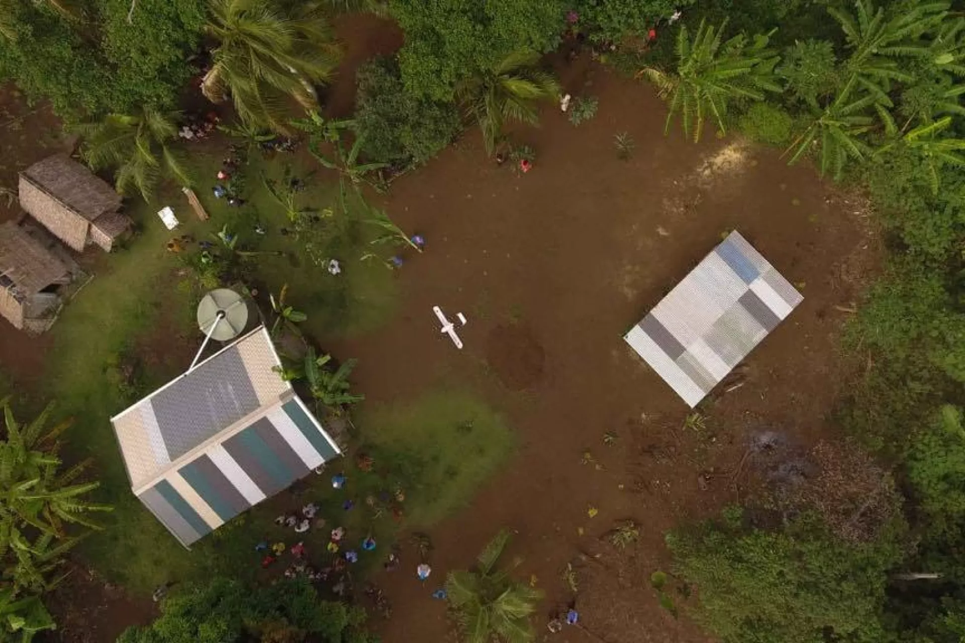 Swoop Aero drone comes into land at Cook&rsquo;s Bay, after taking off from Dillon&rsquo;s Bay and flying 25 minutes over the mountainous terrain, to deliver vaccines to the registered nurse, Miriam Nampil, who is waiting to vaccinate 13 children.
