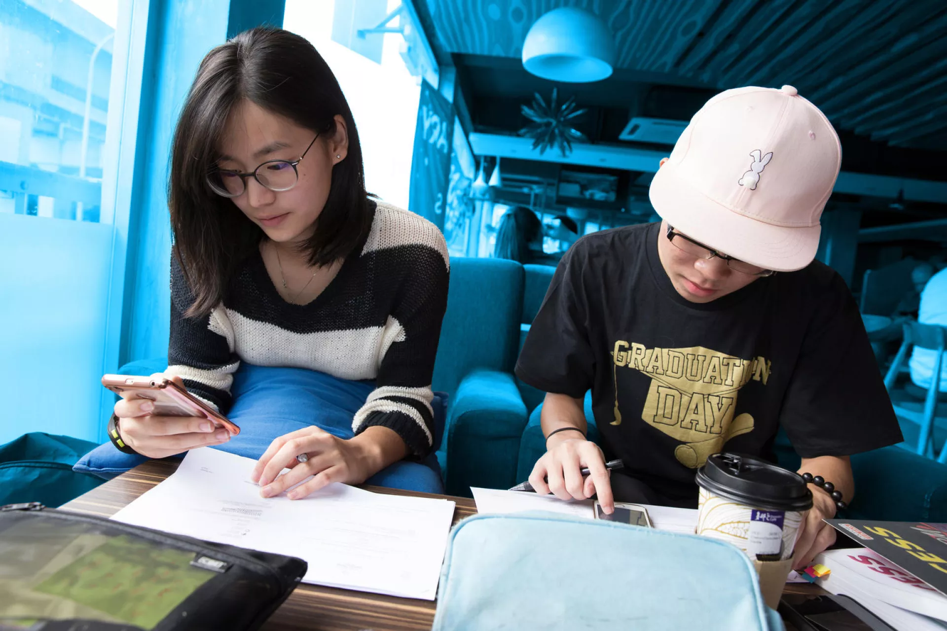 Angeline Chong, a student at the Sekolah Menengah Kebangsaan Subang Jaya school, studies with a fellow student at a cafe in Kuala Lumpur, Malaysia