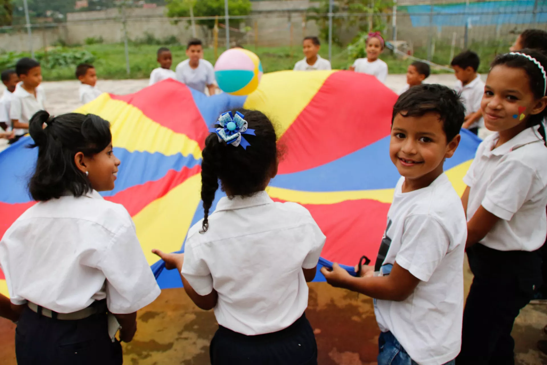 Children participate in recreational activities on the school&rsquo;s sports field of Negro Primero 1 school in Caucaguita, Miranda