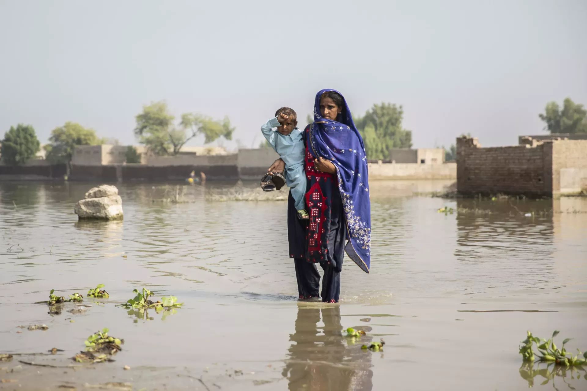 mom and child stand together in water