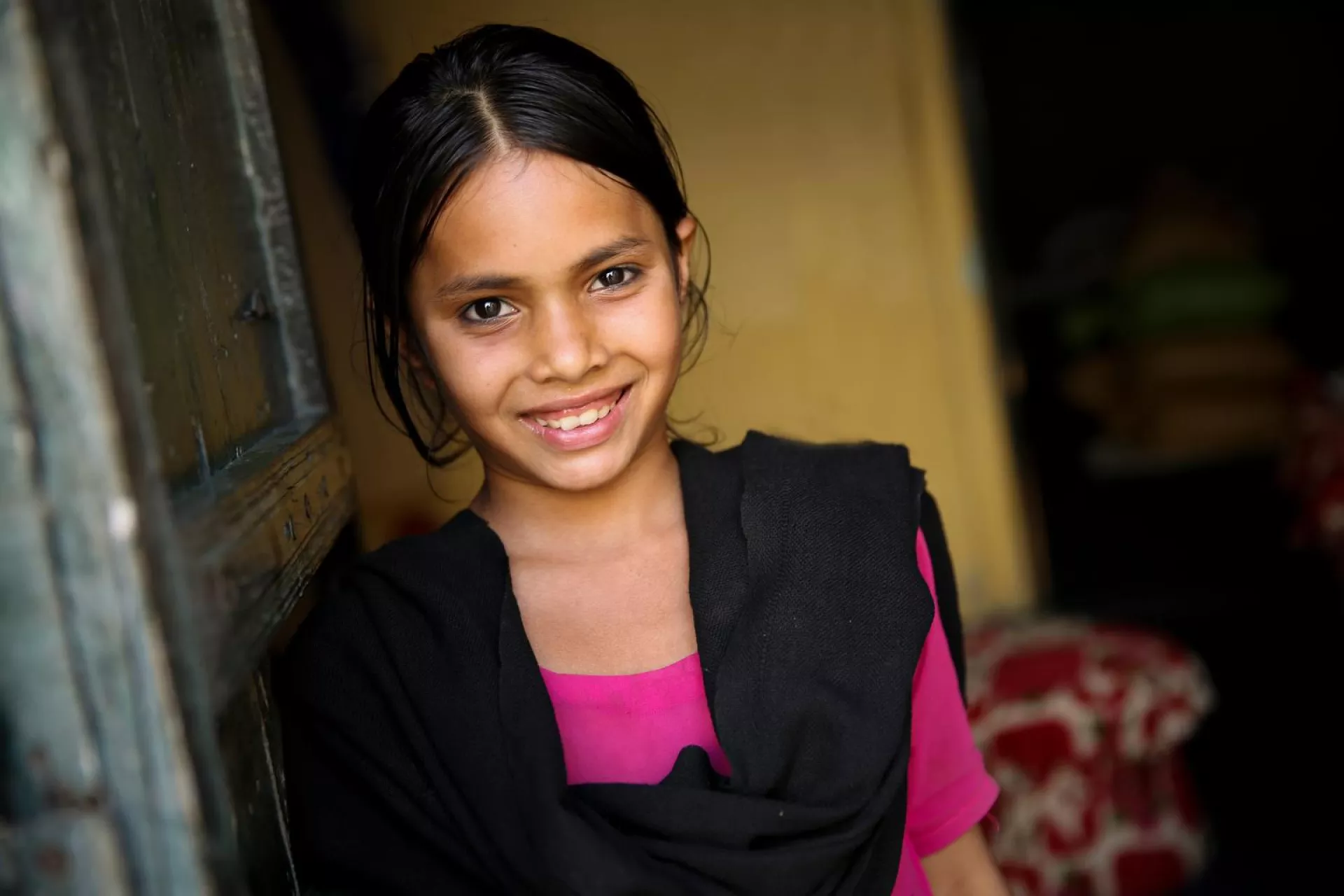In Pakistan, a girl stands in her home, in Kasur District, Punjab Province.
