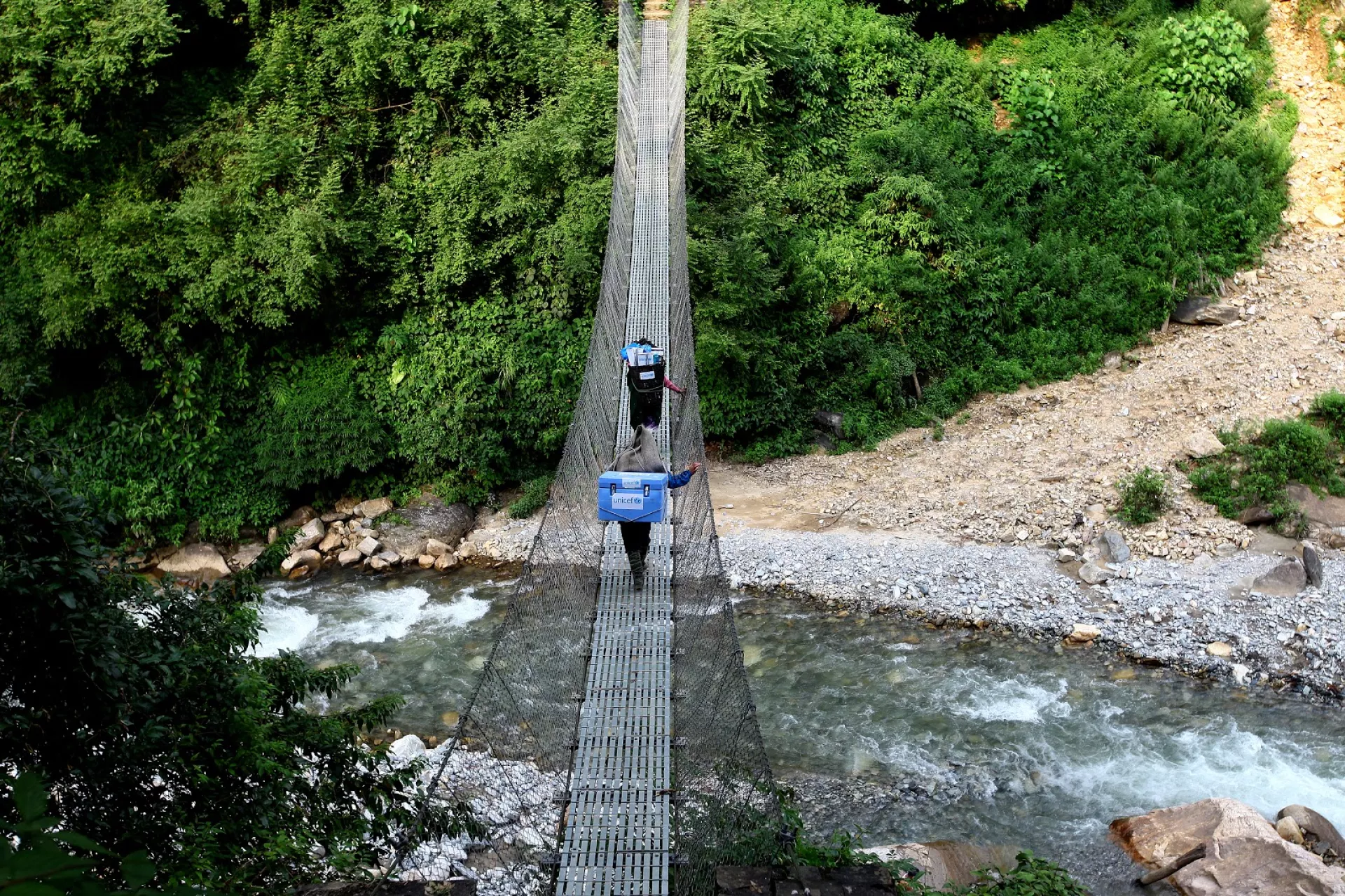person crossing a bridge
