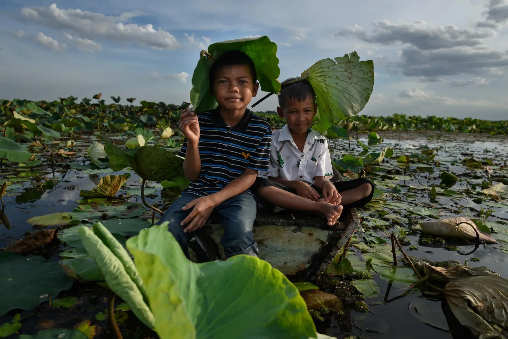 boys sitting in water