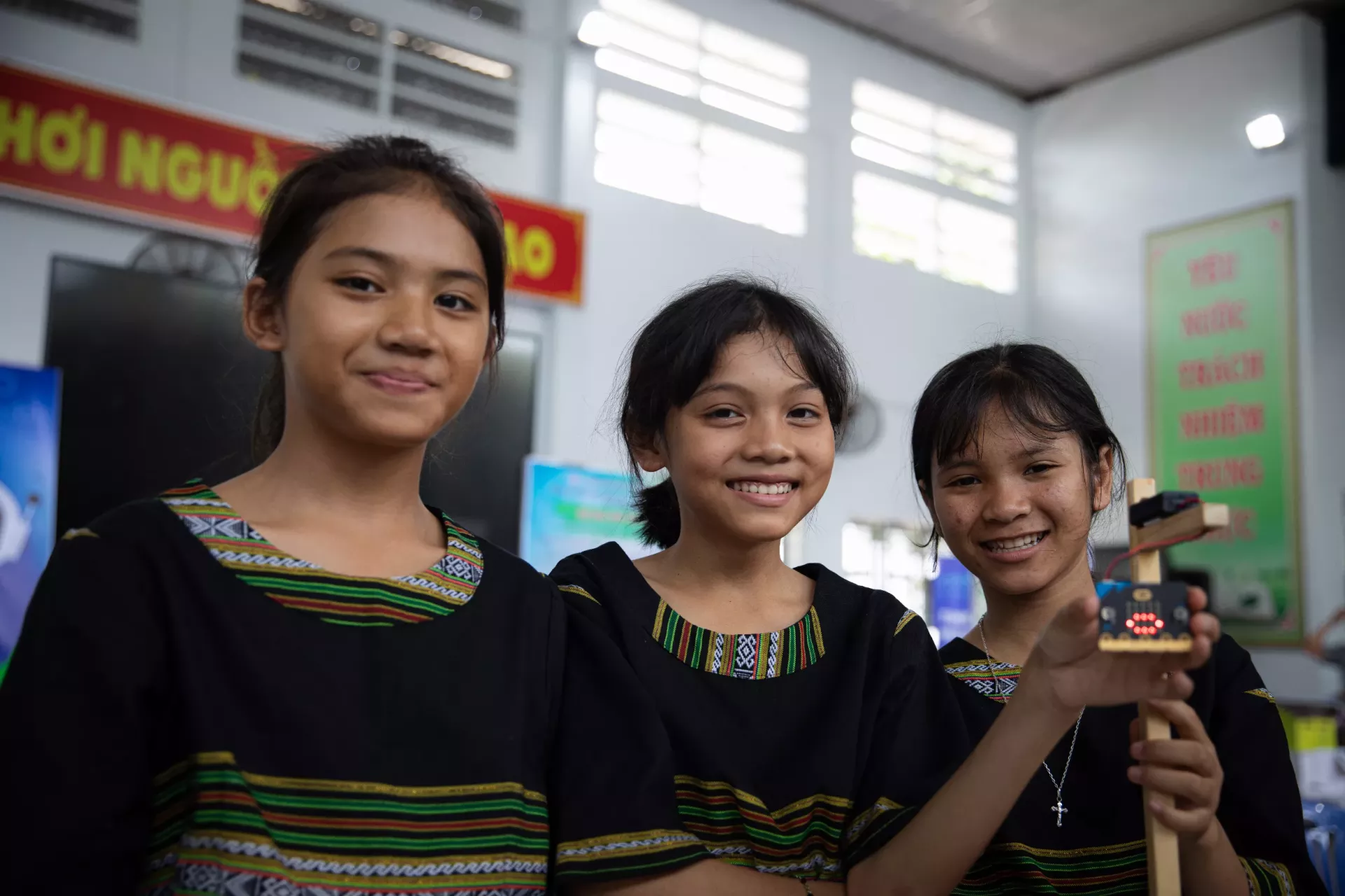 students holding an AI device