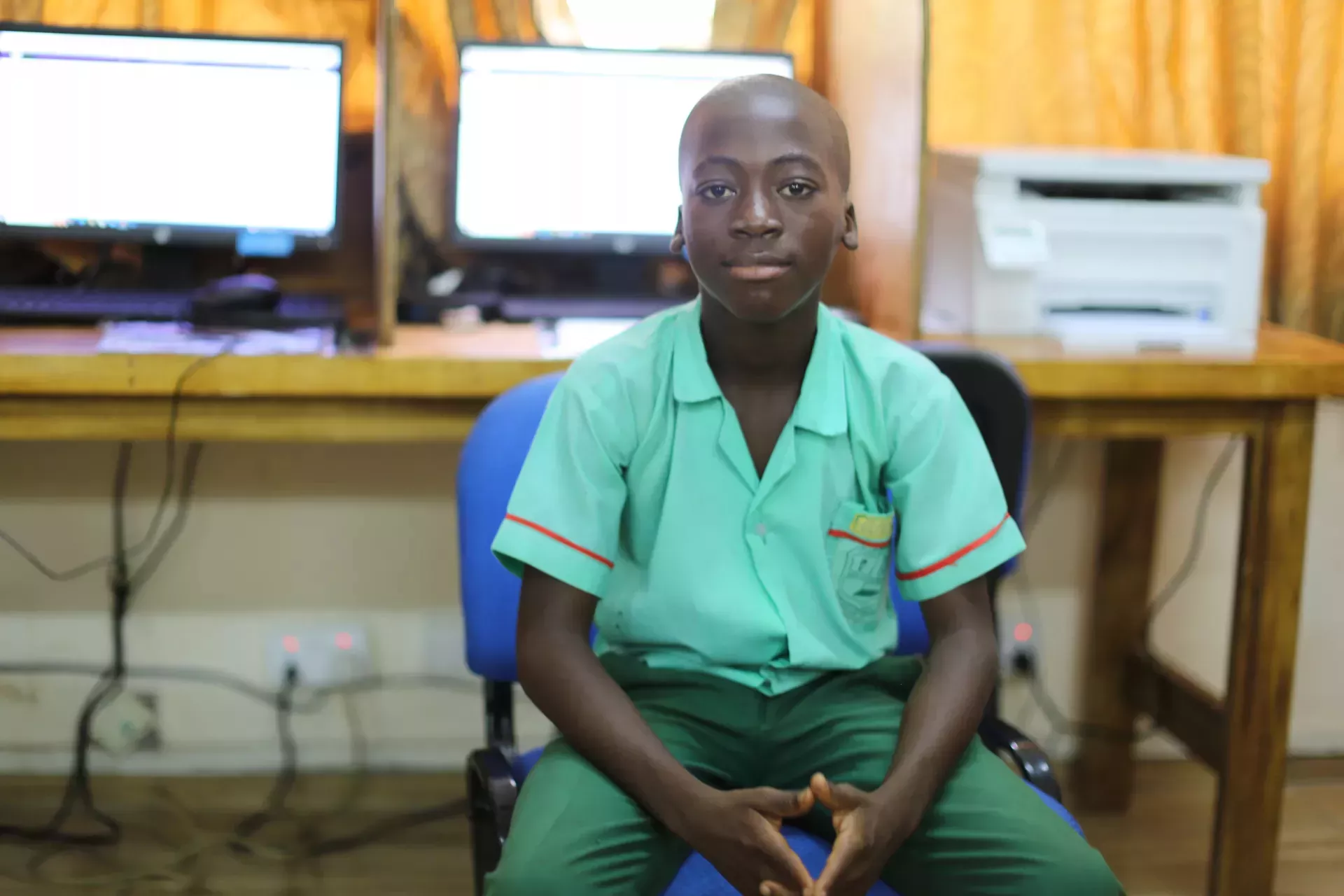 young student sits at a computer desk