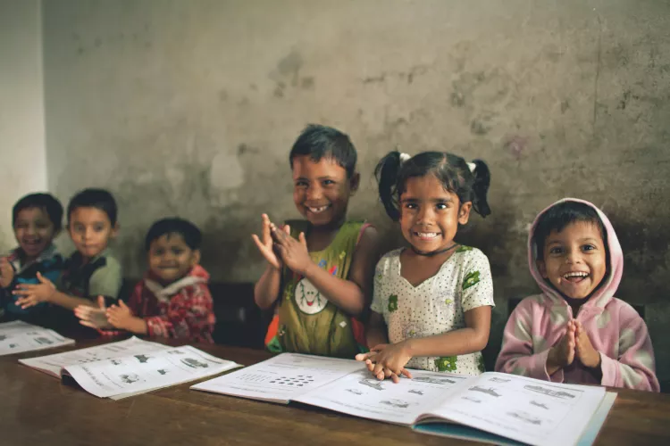 children in school smiling at camera