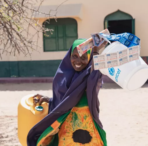 Ebla, a mother of nine, received tokens from UNICEF to select extra WASH items according to her family&rsquo;s needs in drought and flood-affected Kenya. 