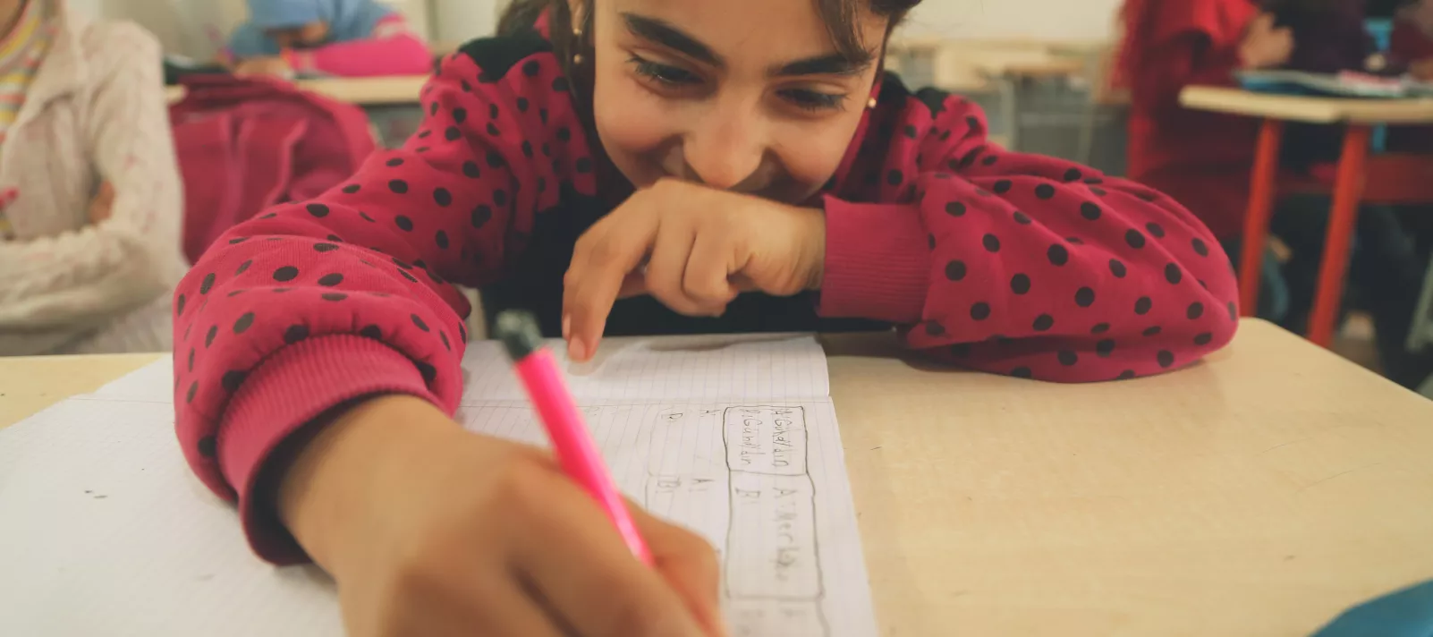 girl drawing on a paper