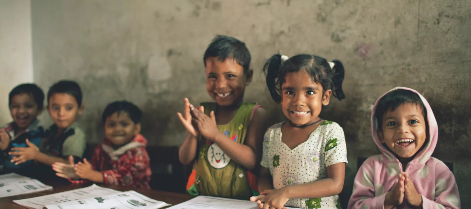 children in school smiling at camera