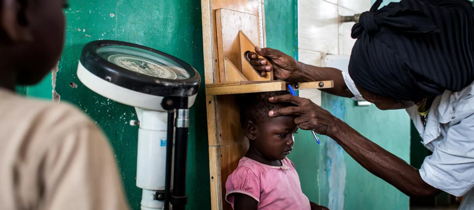 A young girl gets her height measured