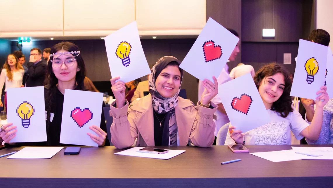 girls holding up signs
