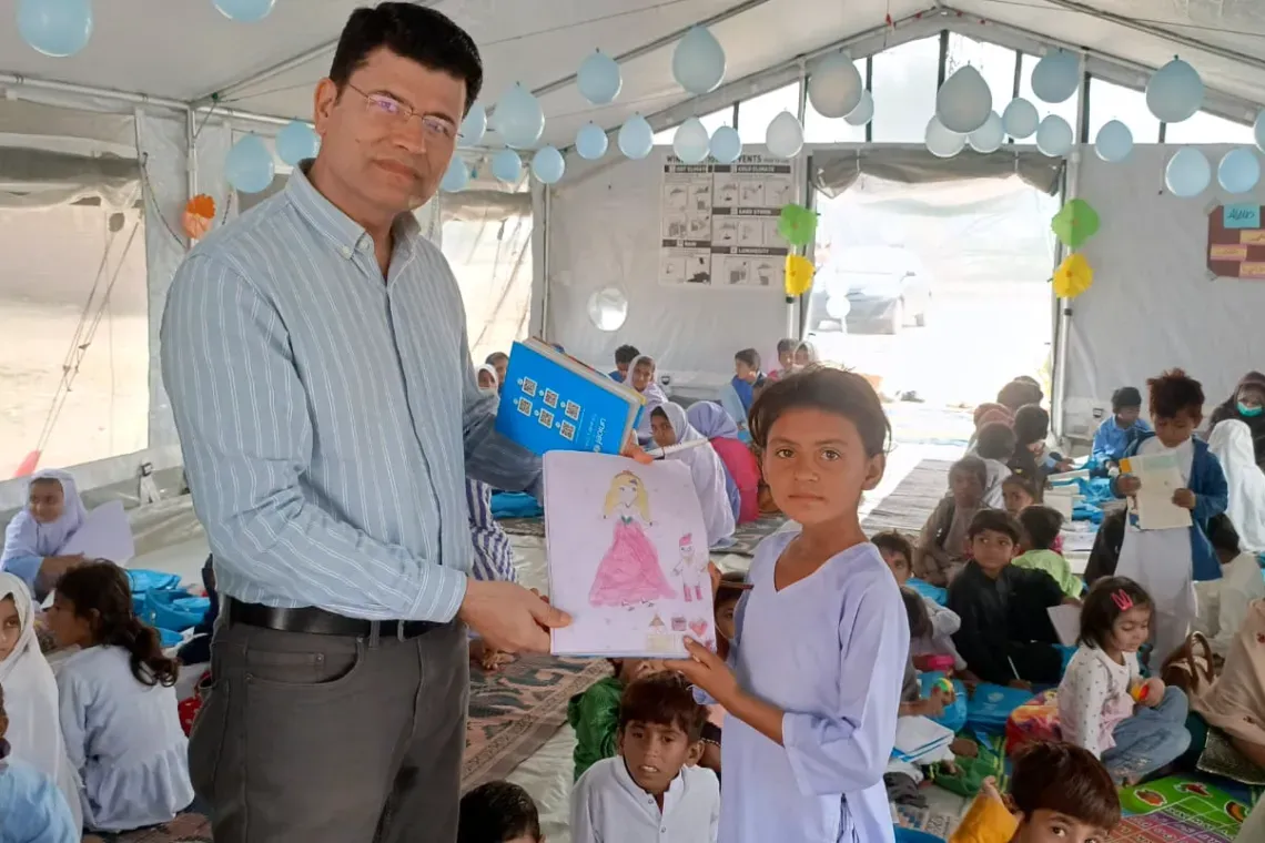 man and child show a drawing