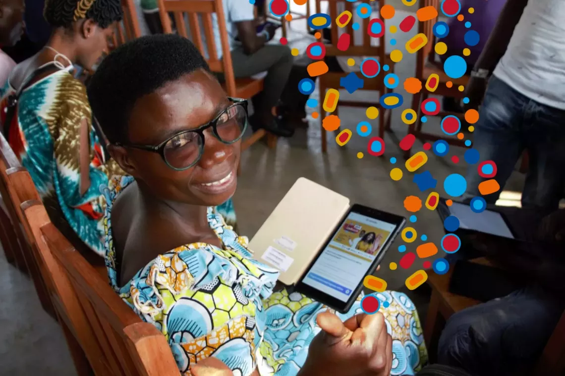 child looking at a phone and smiling