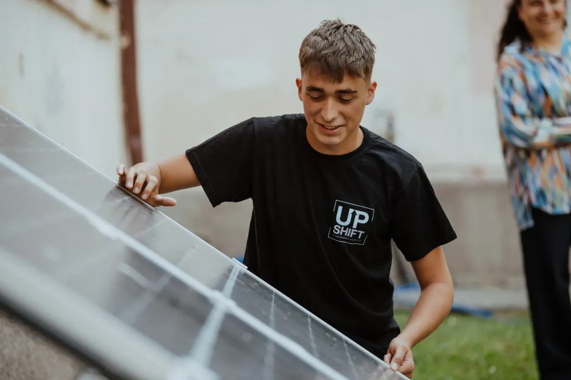 A Student installing solar panels