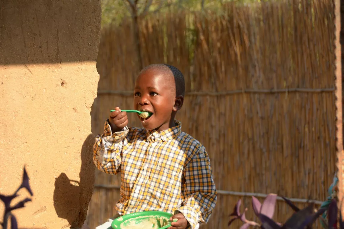 Lumbani eats porridge at his family home in Sigerege in the commercial capital city of Blantyre.