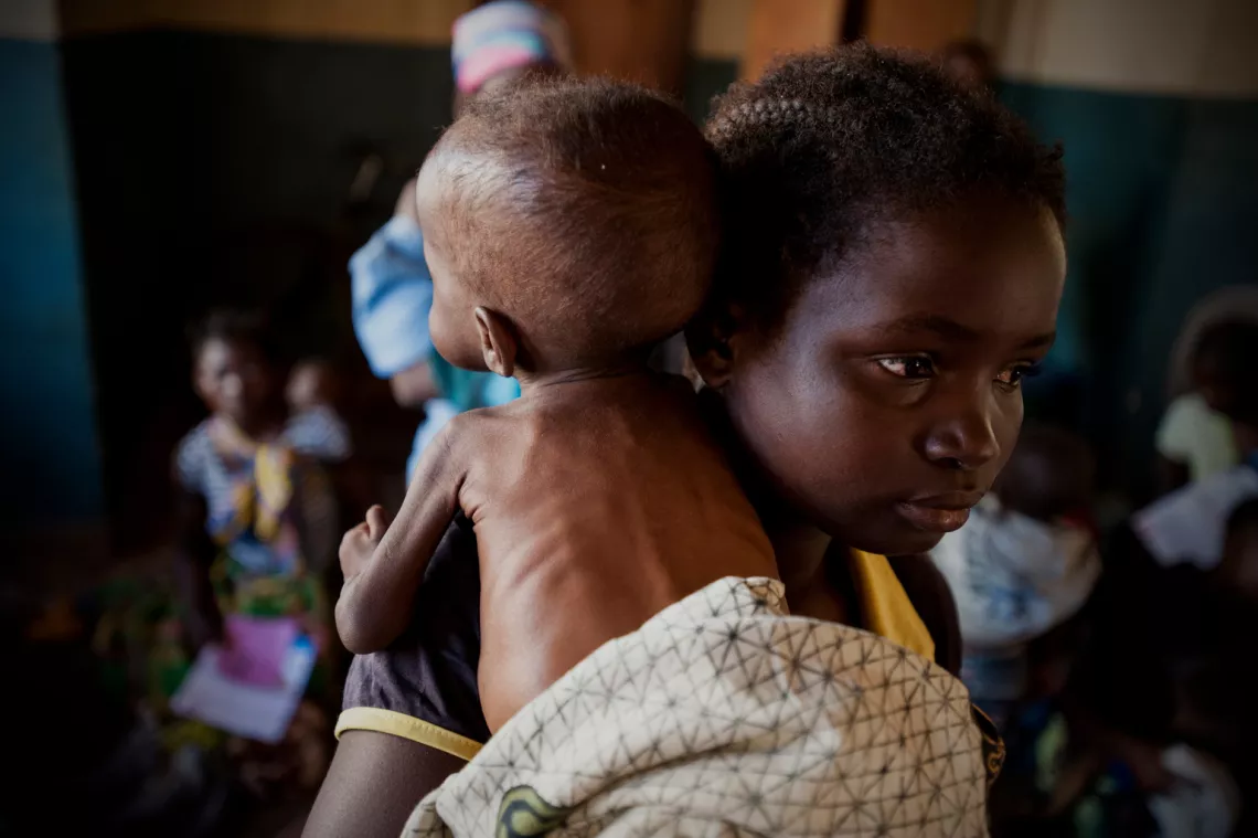 A mother holds a baby at a UNICEF-supported therapeutic feeding centre at the Balaka district hospital in Malawi