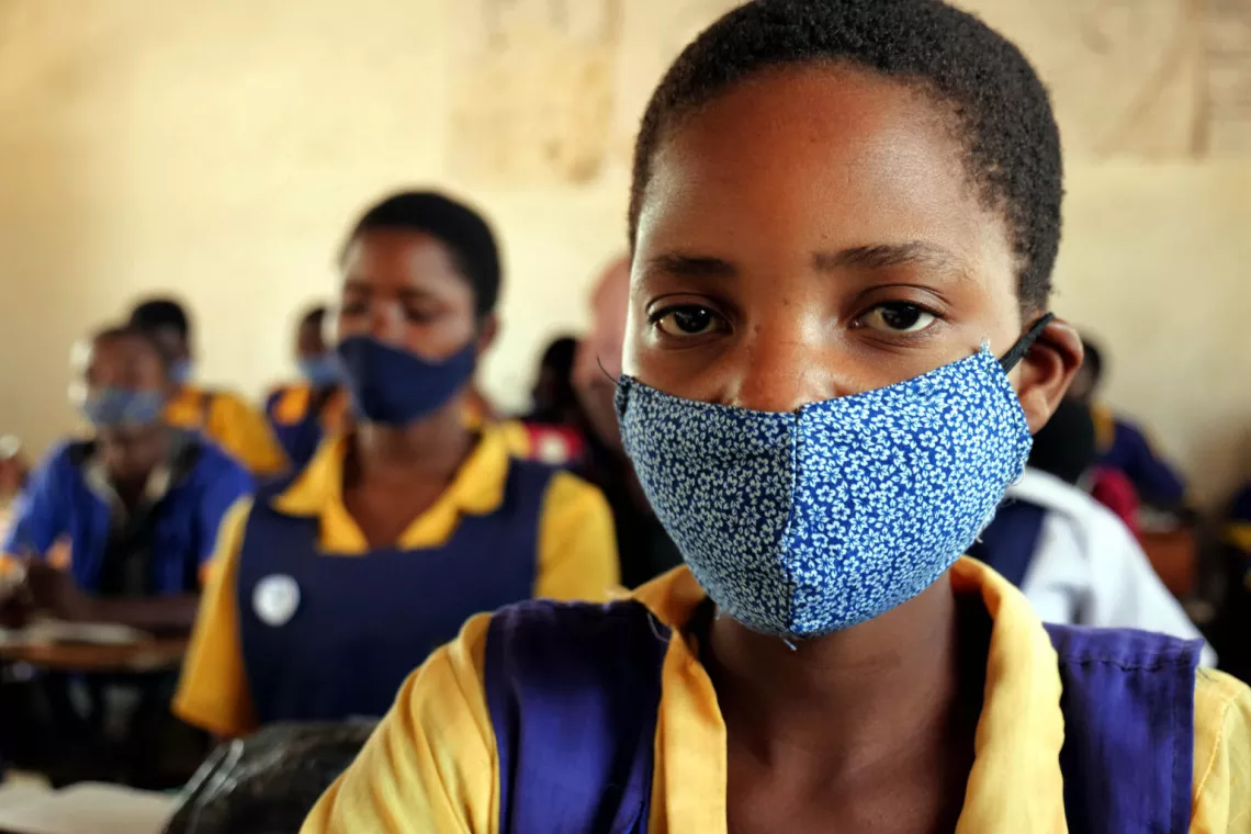 A learner covers her mouth and nose with a homemade mask due to Covid-19 pandemic during a class session at Mchoka primary school in Salima