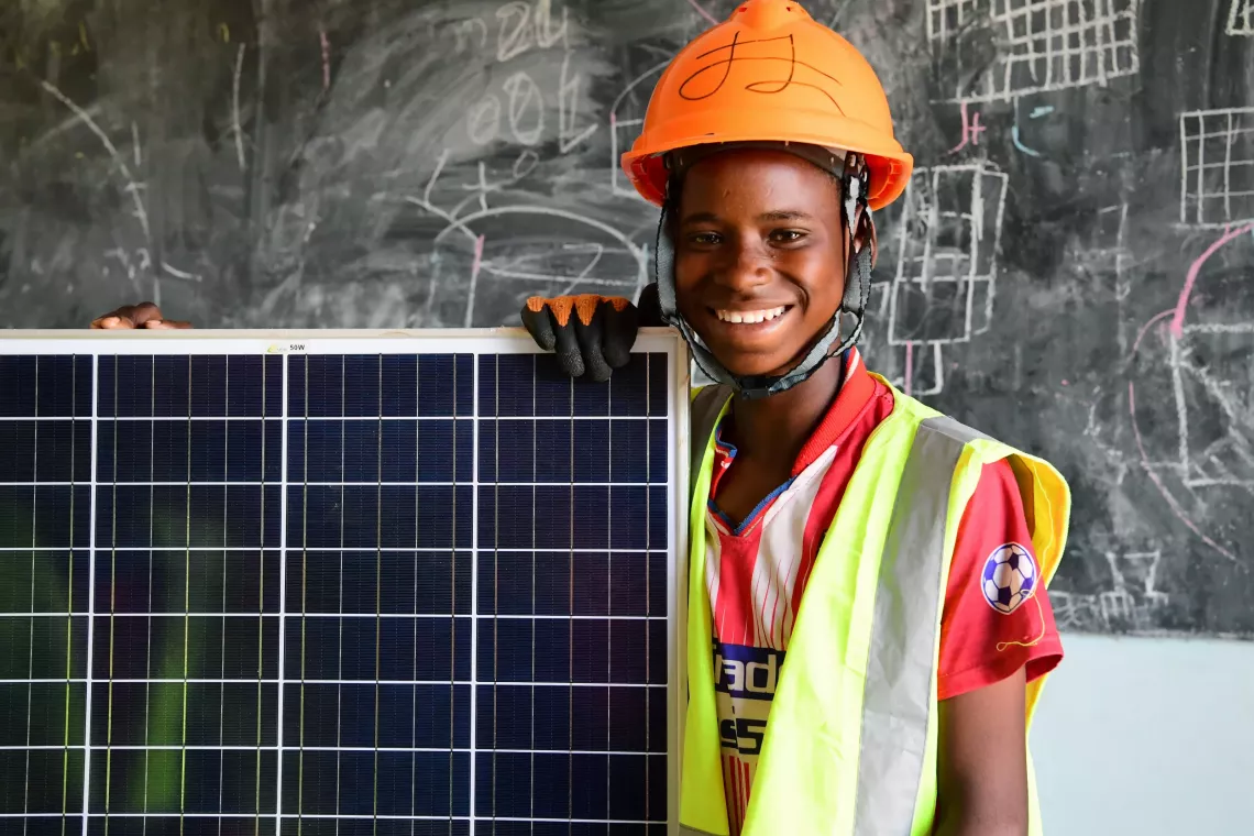 boy holding solar panel