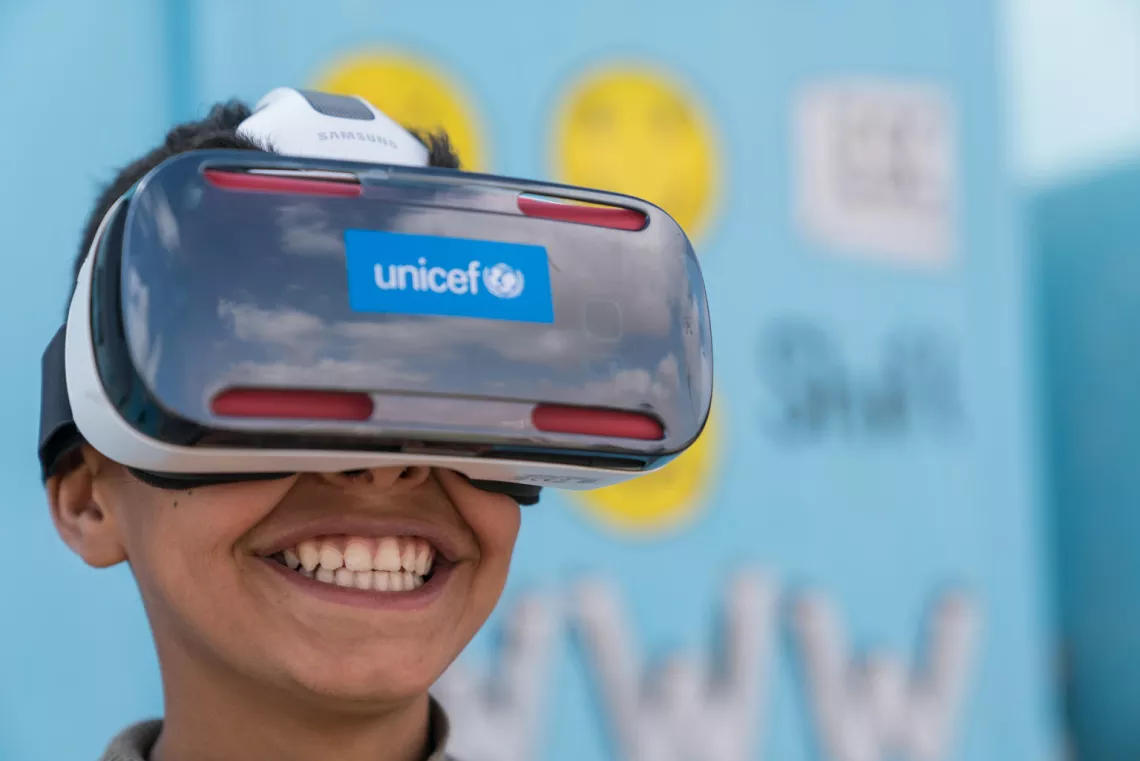 Mansoor,12, watches the virtual reality documentary &lsquo;Clouds over Sidra&rsquo; with a big grin, outside a UNICEF-supported Makani centre in the Za&rsquo;atari camp for Syrian refugees, in Mafraq Governorate, near the Syrian border.