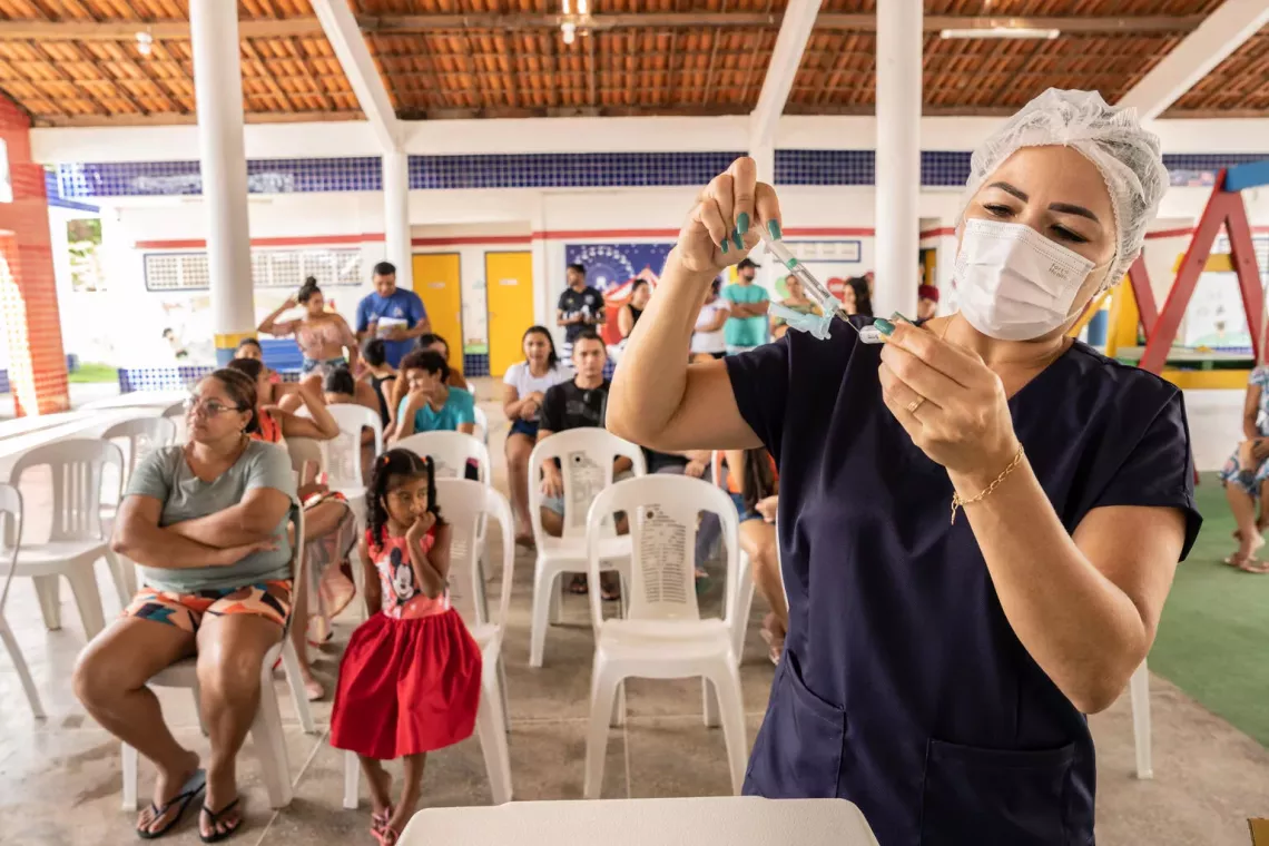 A nurse prepares a vaccination shot in Brazil