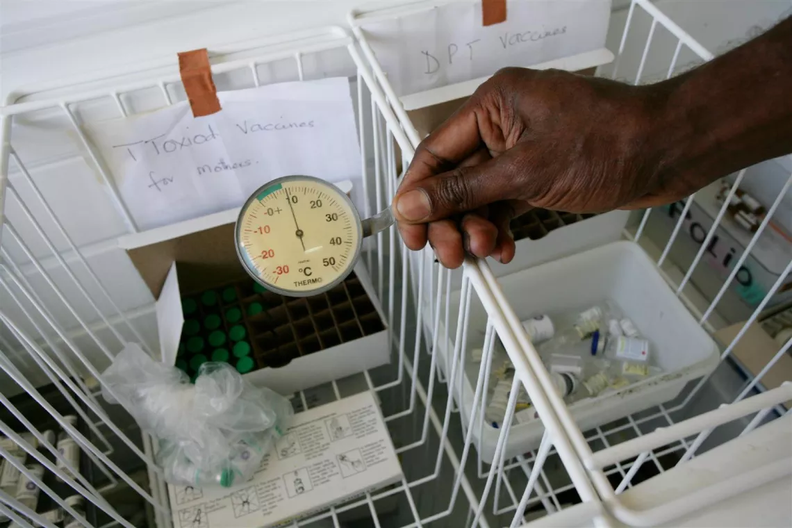 A health worker measures the temperature of a freezer containing vaccines, which must be kept at a constant low temperature so that they retain their potency, in the maternity ward of Port Vila Hospital in Port Vila, the capital, on the island of Efate.