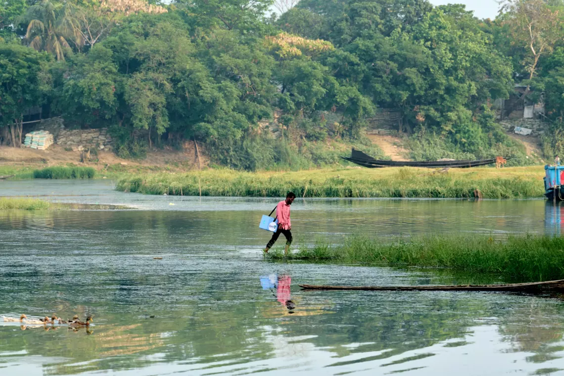 a man walking near water