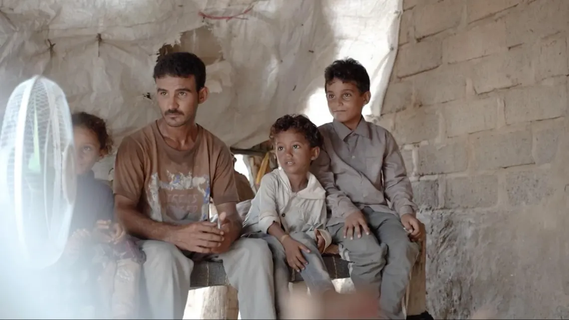a father sitting with his children