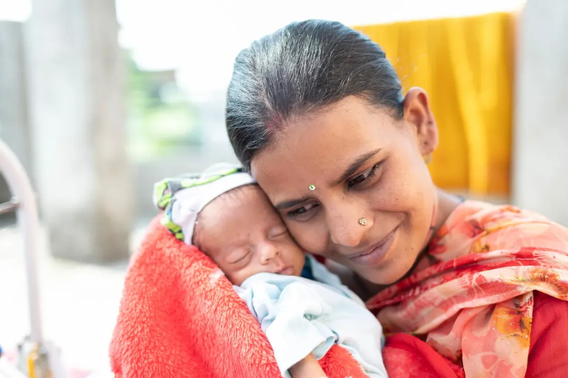  A woman holding a child