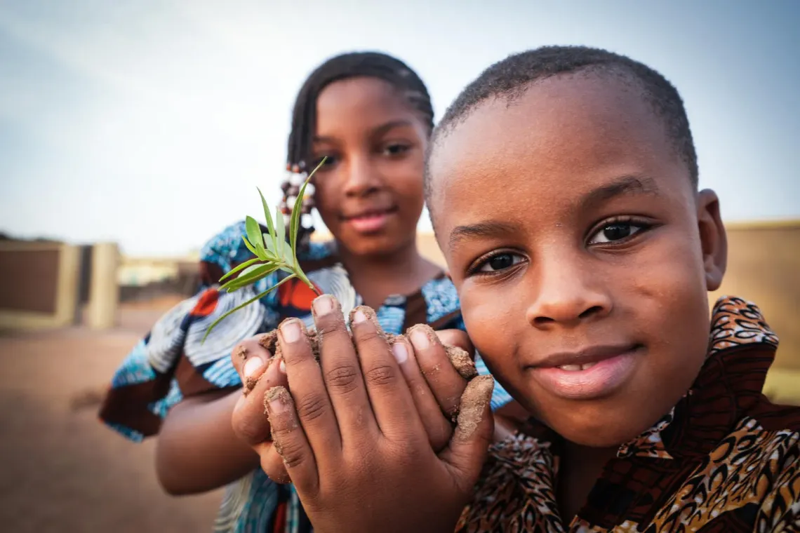 Children holding plants