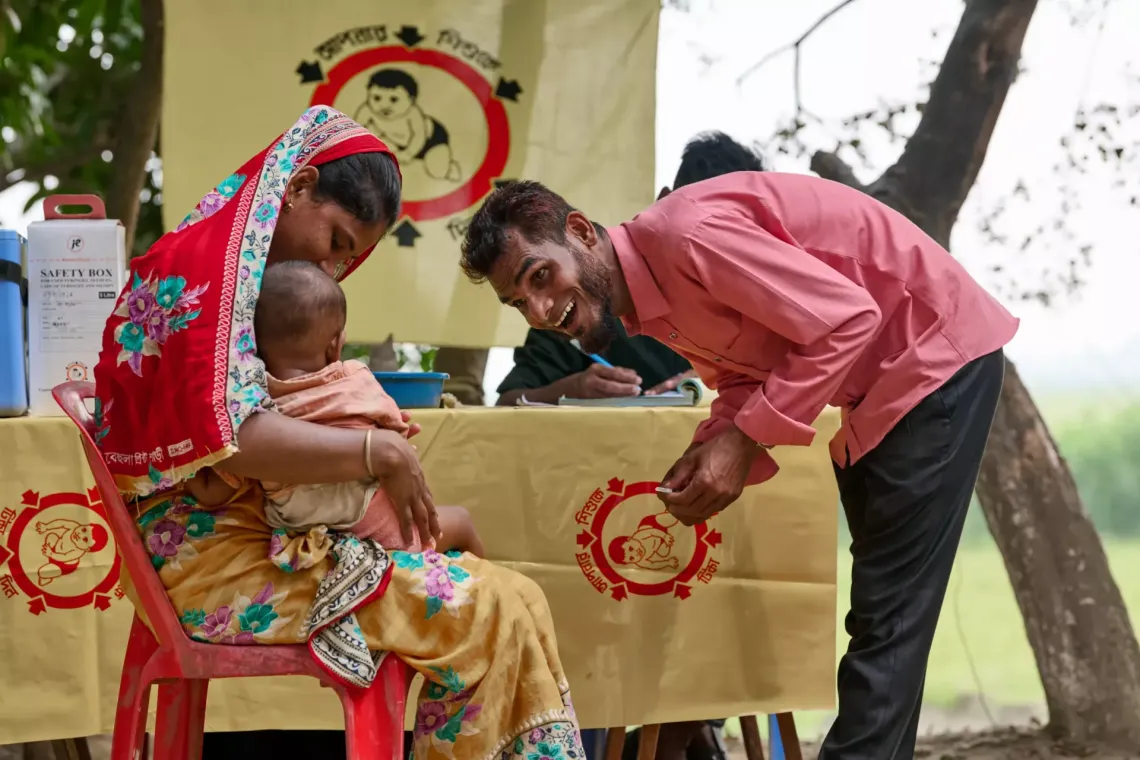 a vaccinator about to administer a shot