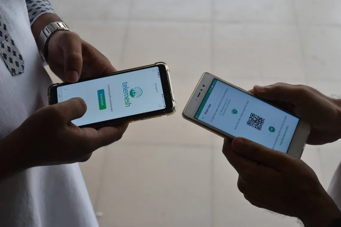 W3 engineers team testing telemesh app on two mobile devices