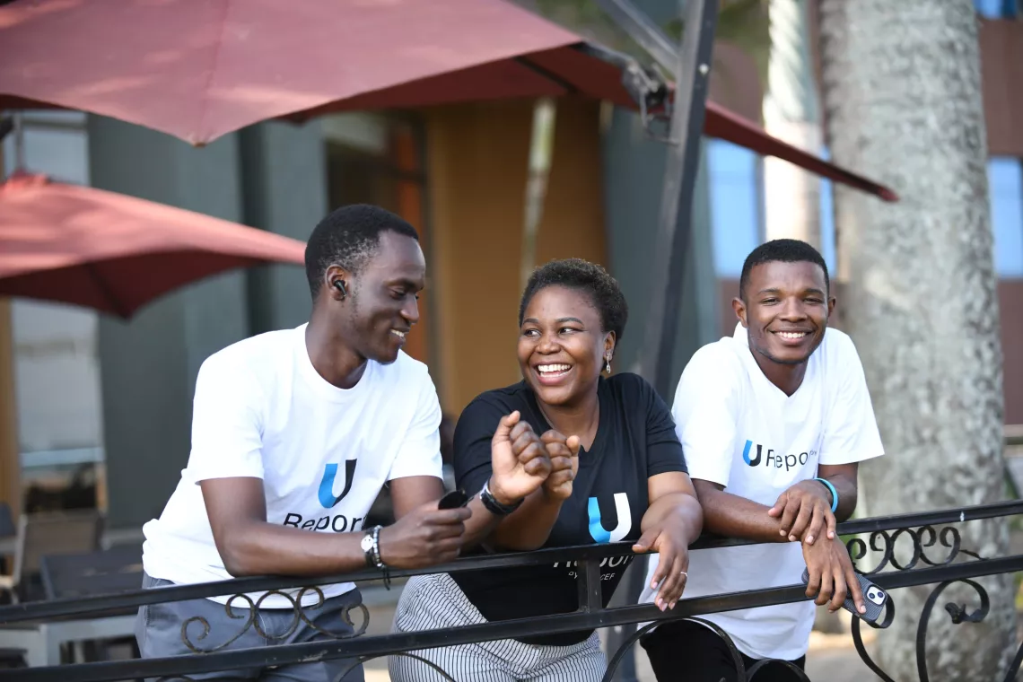 woman smiling with 2 men