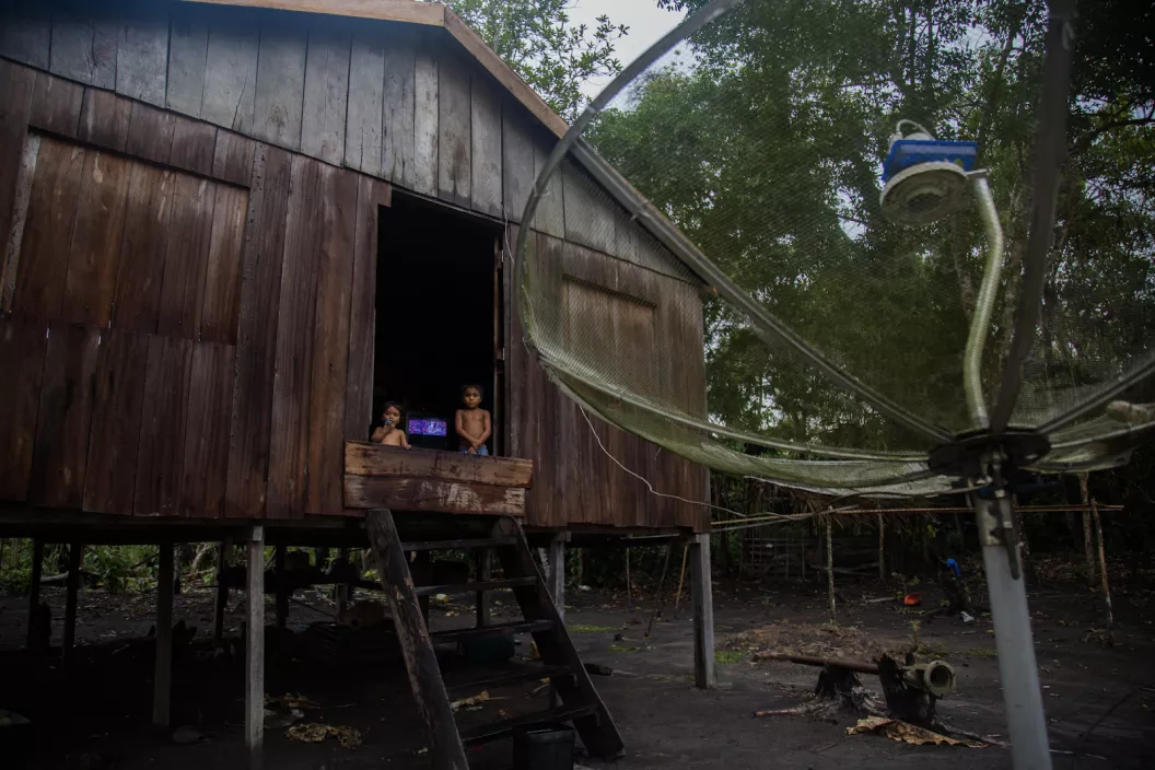 two kids in a house with a big antenna on the side