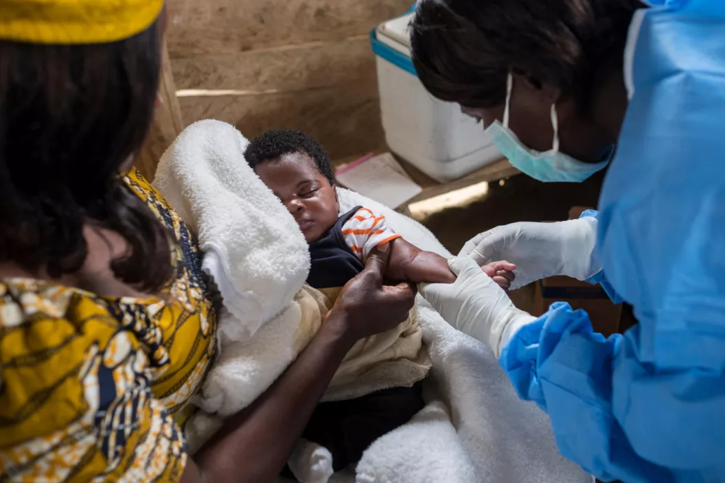 Nurse Jeanne Maskia prepares to vaccinate infant Kavuho during a regularly-scheduled immunization clinic in the village of Kuka, Democratic Republic of the Congo in 2019.