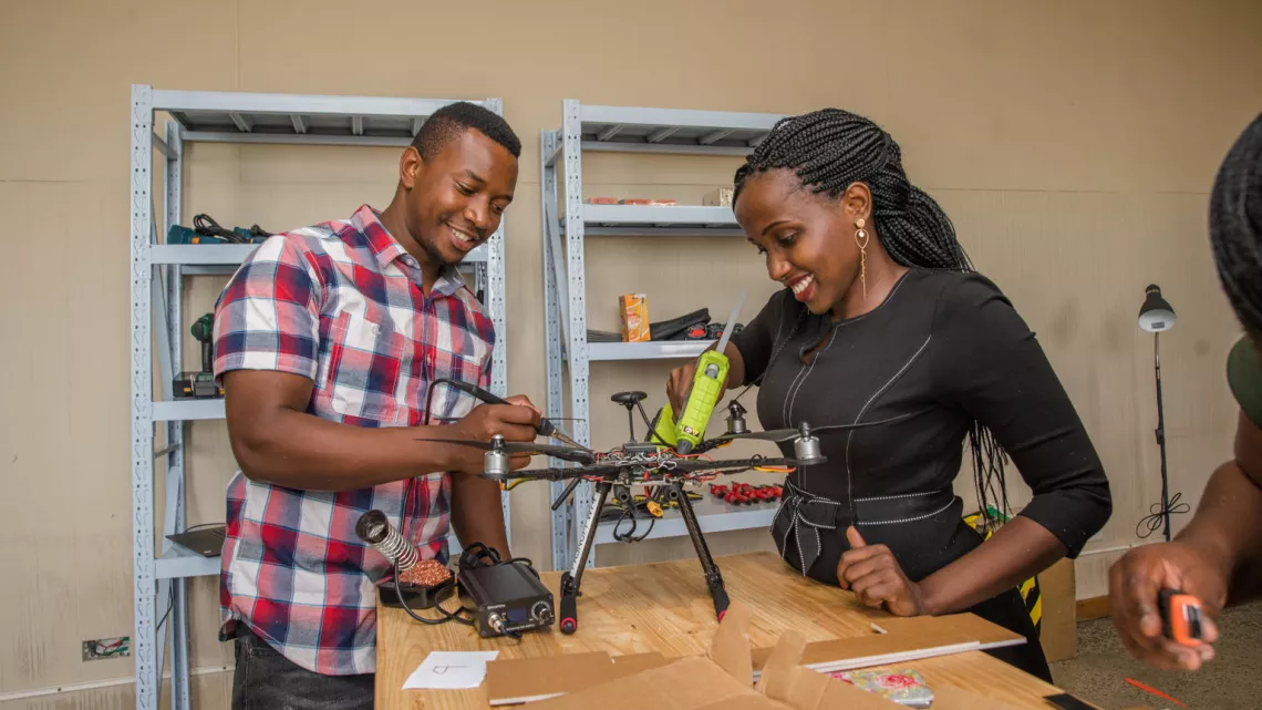 students work together in building a drone