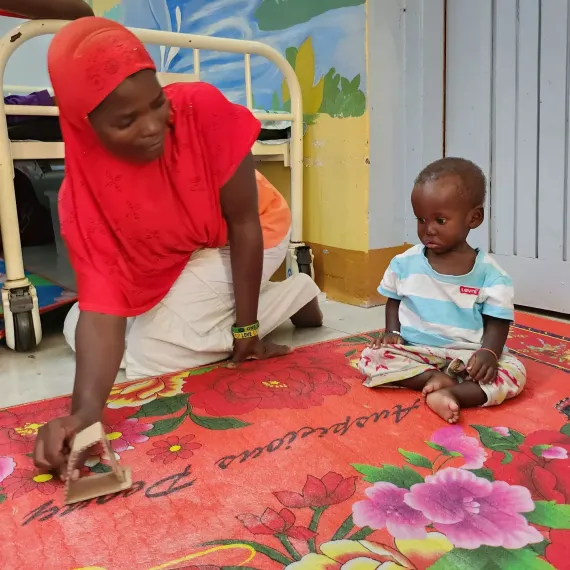 Child with mother playing with toys