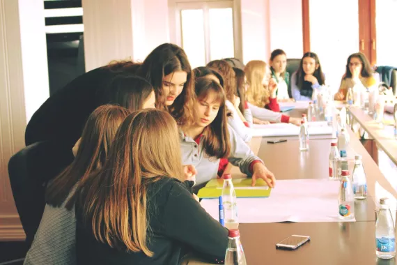 Girls brainstorming in the table